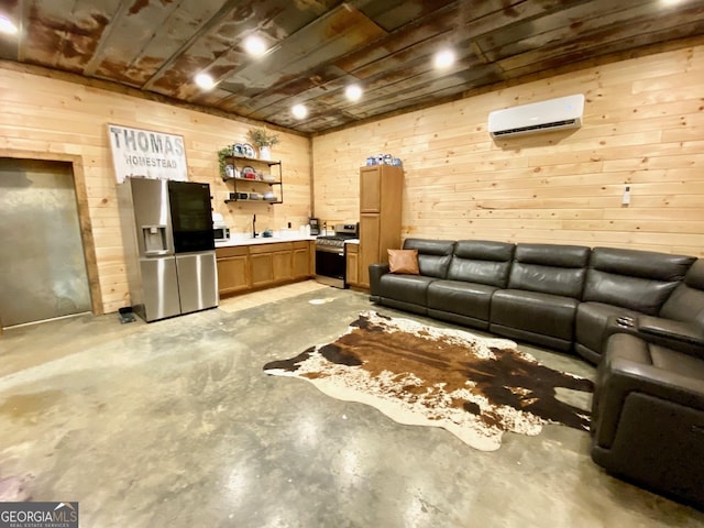 living area with wood walls, a wall unit AC, and unfinished concrete flooring