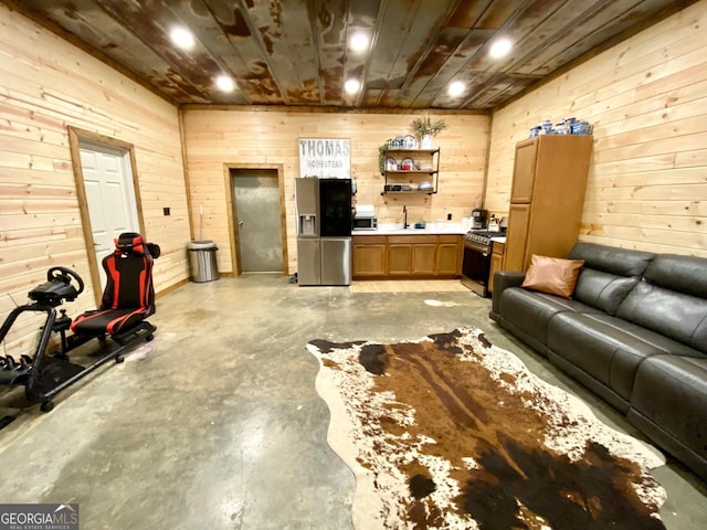 living room with wood walls, wood ceiling, and concrete flooring