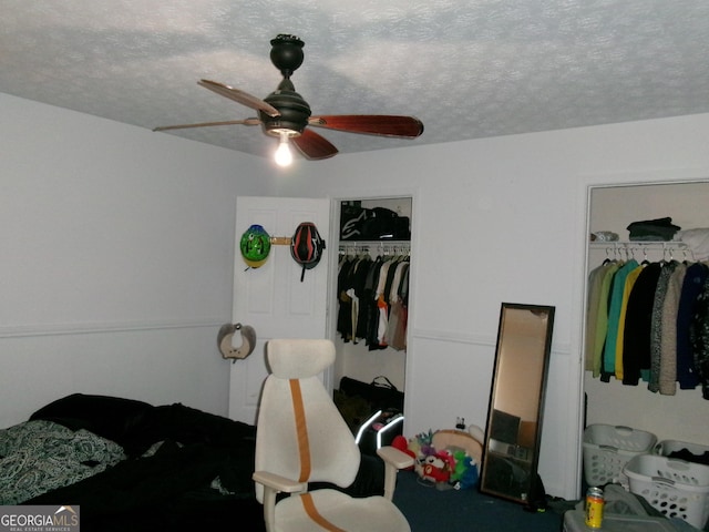 bedroom featuring a ceiling fan, a closet, and a textured ceiling