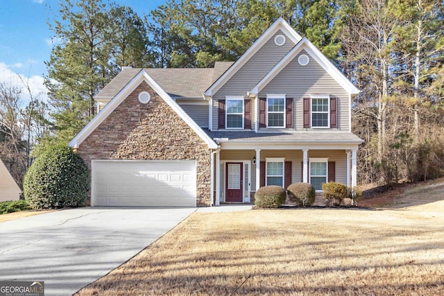 view of front of house with a garage, concrete driveway, stone siding, covered porch, and a front lawn