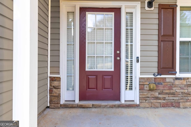 doorway to property featuring stone siding