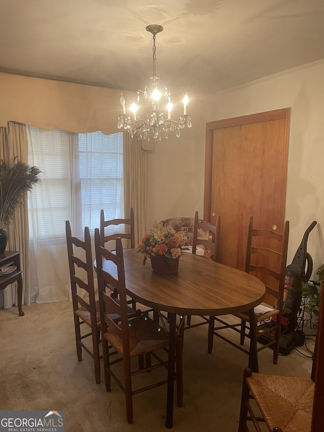 dining space with carpet and a notable chandelier