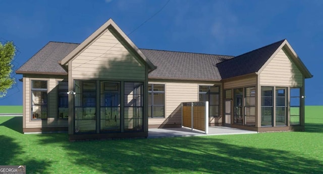 rear view of house featuring a sunroom and a lawn