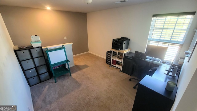 carpeted office space featuring visible vents and baseboards