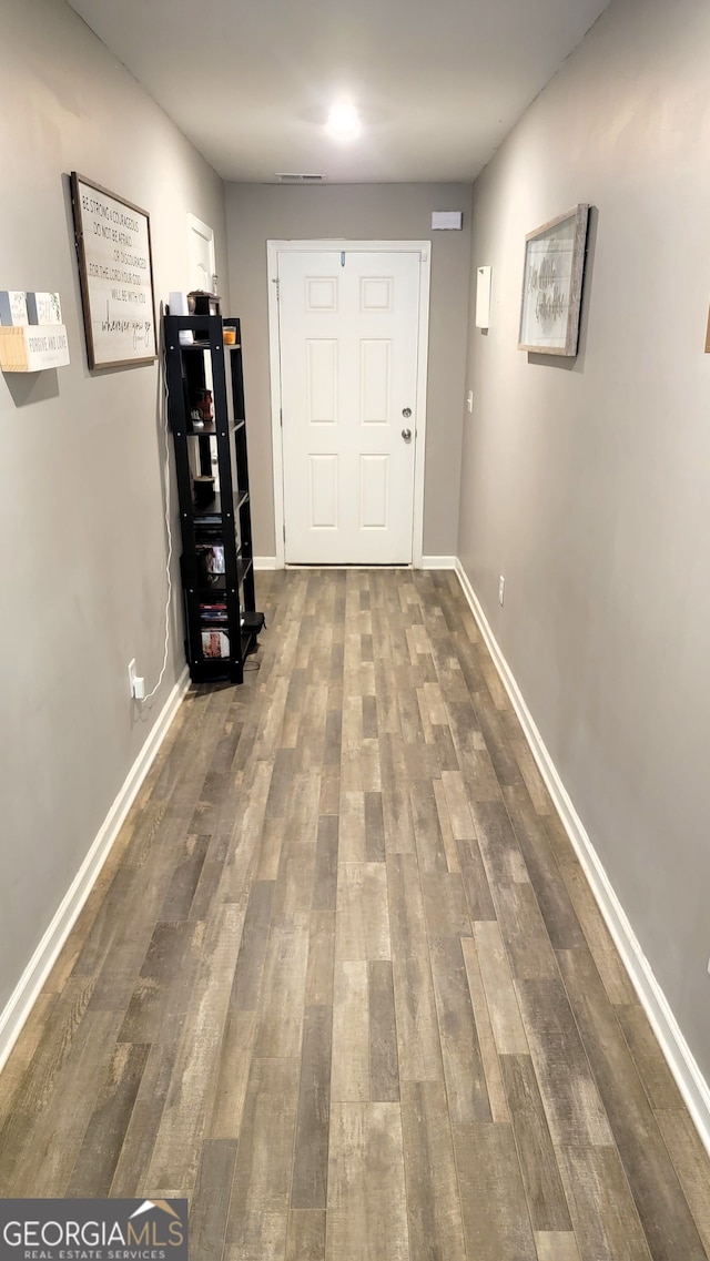 hall with wood finished floors and baseboards