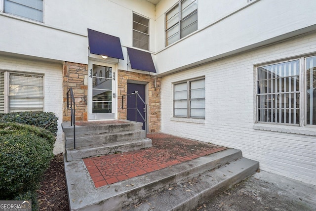 property entrance with brick siding