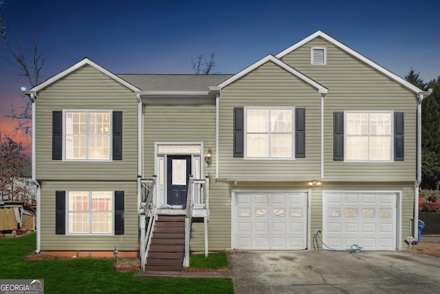 split foyer home featuring a garage and driveway