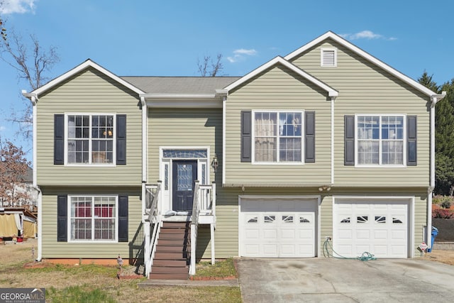 bi-level home featuring a garage and driveway