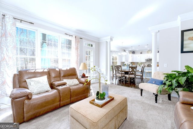 living area with ornate columns and ornamental molding