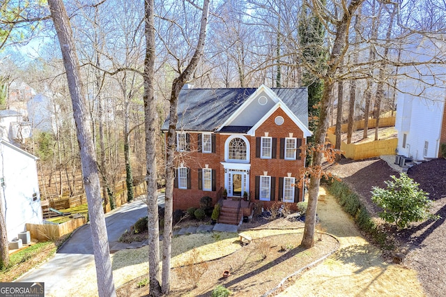 view of front of property featuring driveway and brick siding