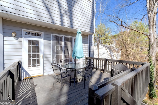 wooden deck with outdoor dining area