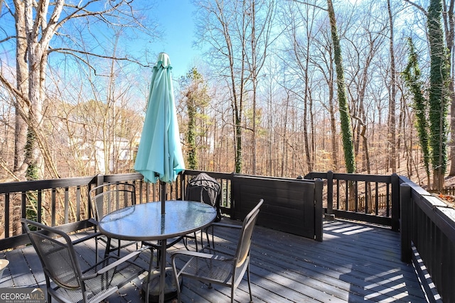 wooden terrace featuring outdoor dining space