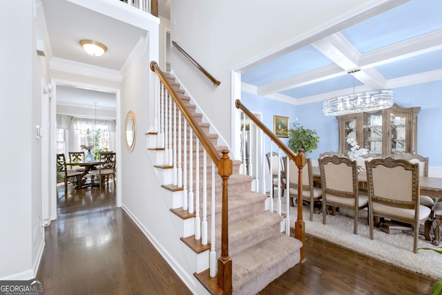 stairway with beamed ceiling, coffered ceiling, wood finished floors, and baseboards