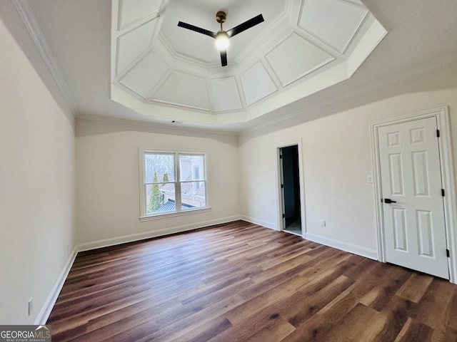 empty room featuring ornamental molding, coffered ceiling, baseboards, and dark wood-style floors