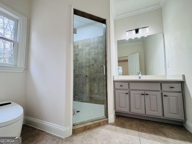 bathroom with ornamental molding, a stall shower, vanity, and baseboards