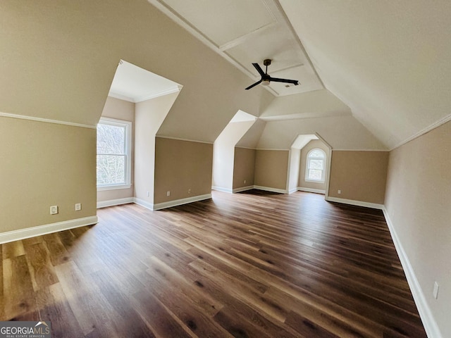 additional living space with lofted ceiling, baseboards, and dark wood-type flooring