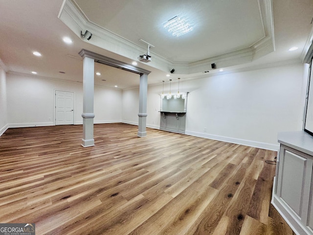 below grade area with baseboards, recessed lighting, wood finished floors, and crown molding