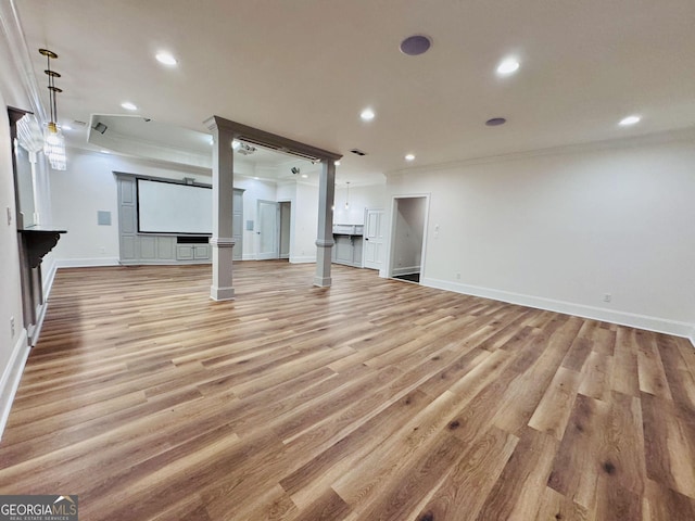 unfurnished living room featuring ornamental molding, recessed lighting, baseboards, and light wood finished floors