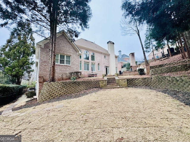 back of house with brick siding