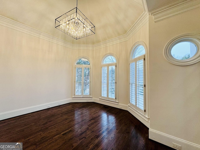 unfurnished room featuring a notable chandelier, baseboards, ornamental molding, and dark wood-type flooring