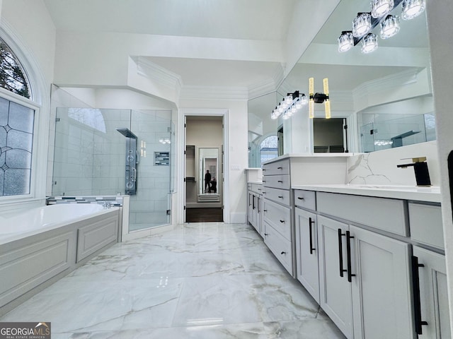 full bathroom featuring marble finish floor, a garden tub, crown molding, a shower stall, and vanity