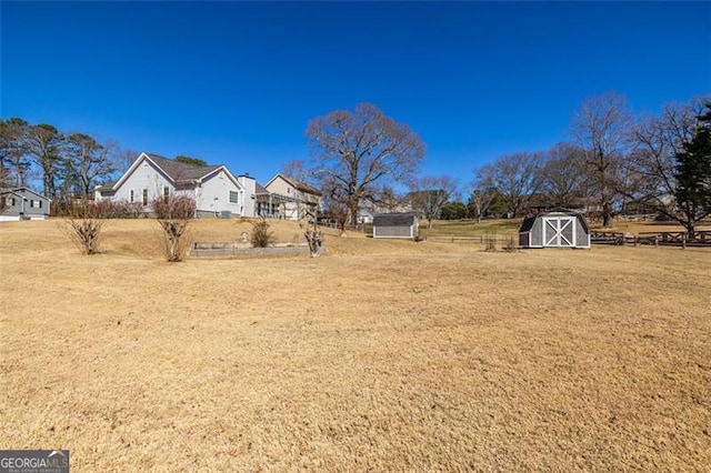 view of yard featuring a storage shed and an outdoor structure