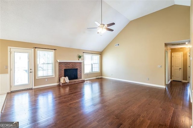 unfurnished living room with dark wood-style flooring, a fireplace, visible vents, ceiling fan, and high vaulted ceiling