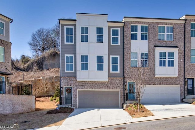 view of front of home featuring a garage, brick siding, driveway, and fence