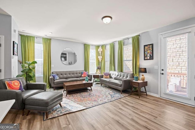 living room with light wood finished floors and baseboards