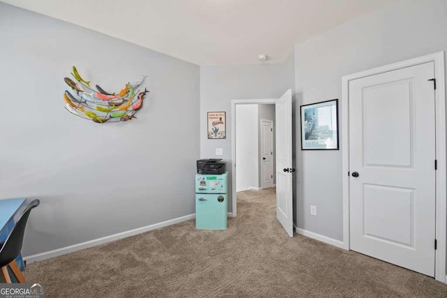 unfurnished bedroom featuring light carpet and baseboards