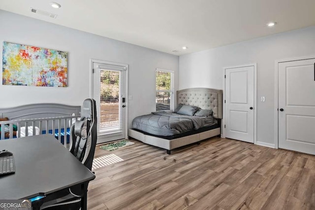 bedroom with access to exterior, recessed lighting, visible vents, and light wood-style flooring