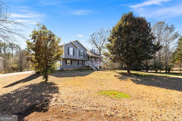 exterior space featuring a porch and fence