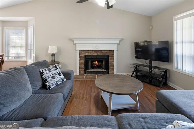 living area featuring lofted ceiling, dark wood-style flooring, and a healthy amount of sunlight