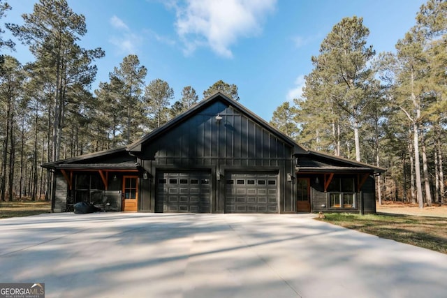 view of front of property featuring driveway, a garage, and board and batten siding