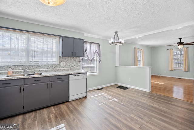 kitchen with wood finished floors, white dishwasher, a sink, and gray cabinetry