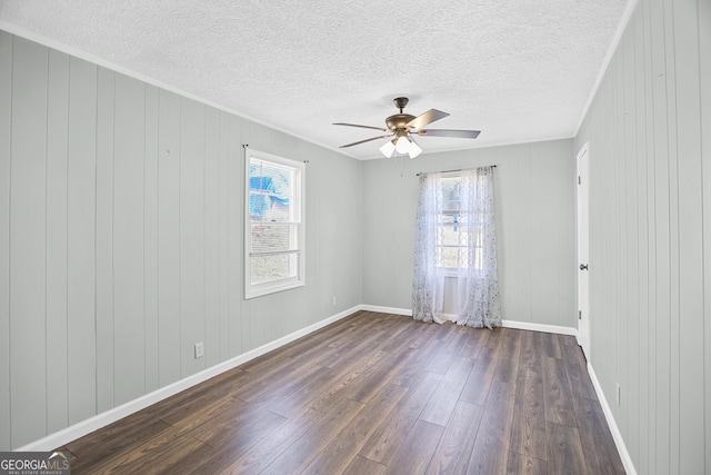 spare room with dark wood-type flooring, a textured ceiling, baseboards, and a ceiling fan