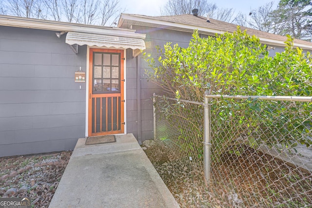 view of exterior entry with fence