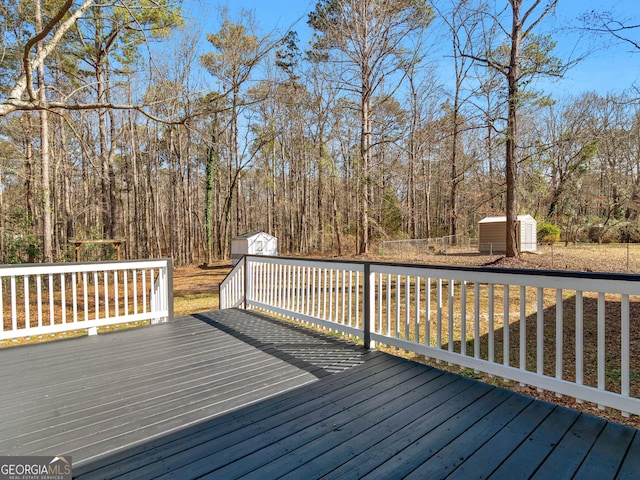 wooden terrace with an outdoor structure and a storage shed