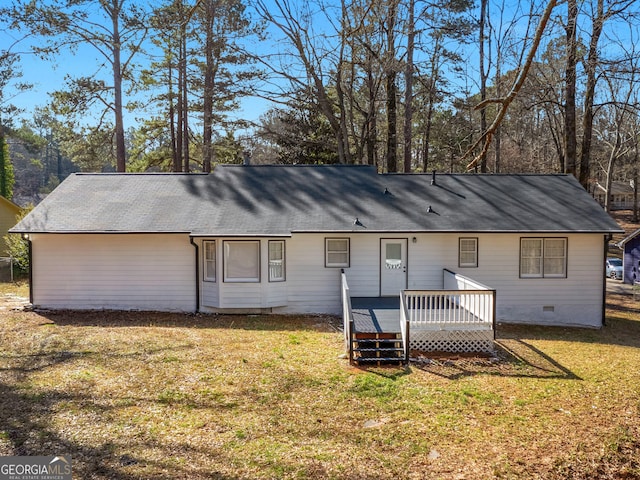 rear view of house with crawl space, a yard, and a deck