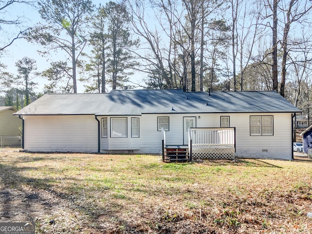 rear view of property featuring crawl space, a lawn, and a wooden deck