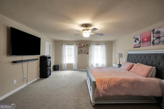 carpeted bedroom featuring a ceiling fan, a textured ceiling, and baseboards