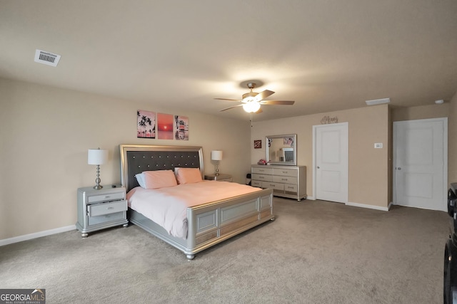 carpeted bedroom featuring a ceiling fan, visible vents, and baseboards