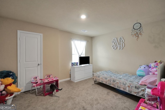 bedroom with visible vents and light colored carpet