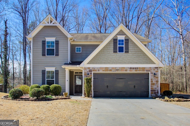 view of front of house featuring a garage, stone siding, and driveway