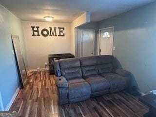 living area featuring baseboards and wood finished floors