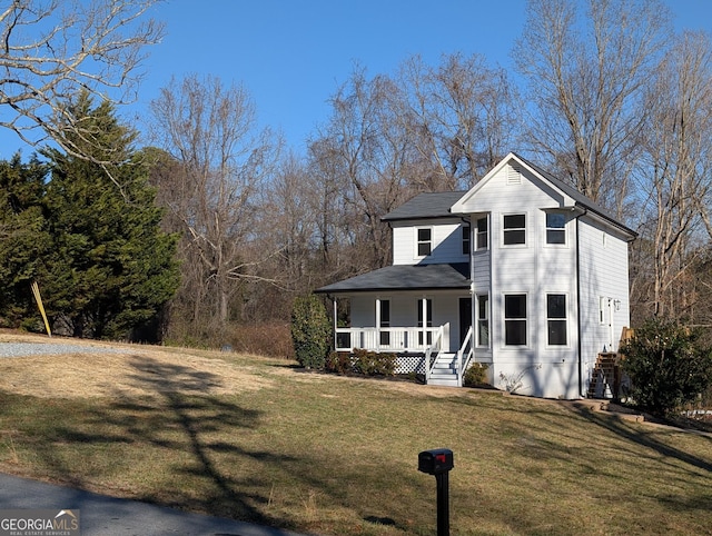 view of front facade with a front lawn and a porch