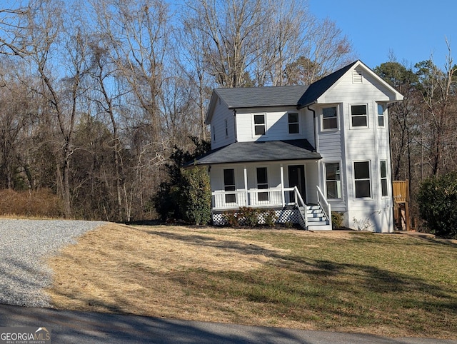 view of front of home with covered porch and a front yard