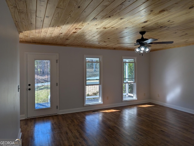 interior space featuring a ceiling fan, wooden ceiling, baseboards, and wood finished floors