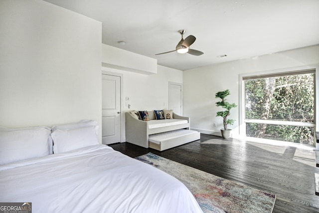 bedroom featuring visible vents, dark wood finished floors, and ceiling fan