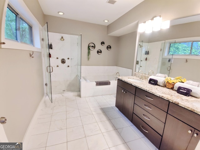 full bathroom featuring visible vents, a stall shower, a garden tub, and vanity